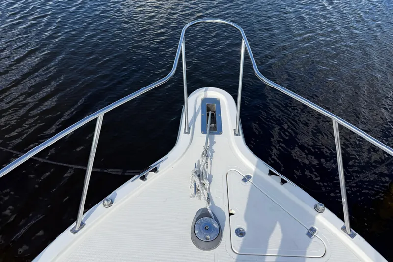 Slide: The Image of Bow view of 2004 Pursuit 3100 Offshore boat on water. - 31