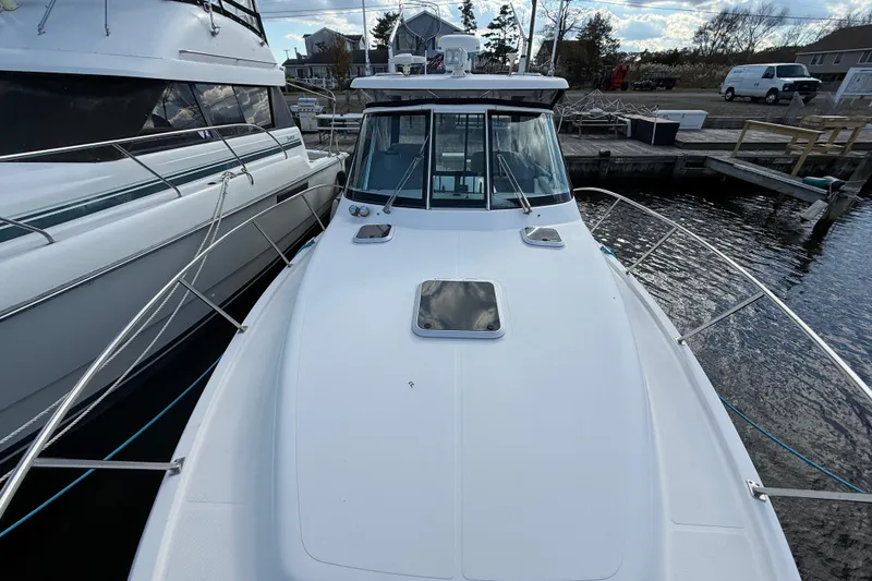 Slide: The Image of 2004 Pursuit 3100 Offshore boat docked at marina, viewed from bow. - 33