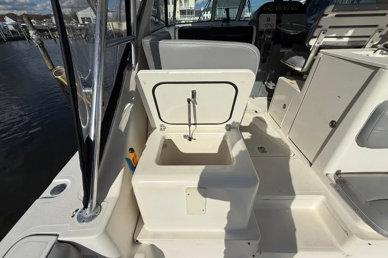 Slide: The Image of 2004 Pursuit 3100 Offshore boat interior with open storage compartment. - 36