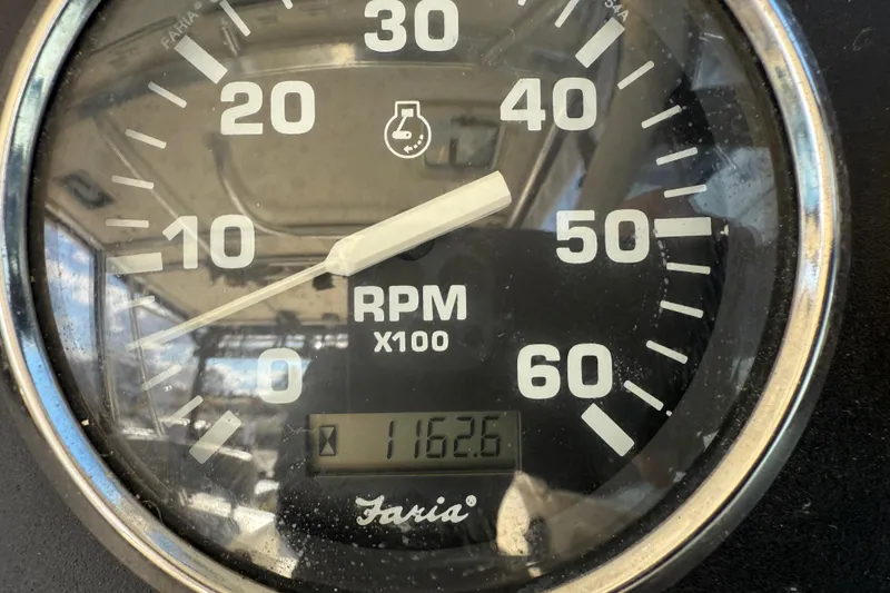 Slide: The Image of Close-up of a Faria tachometer showing 1162.6 RPM on a 2004 Pursuit 3100 Offshore. - 39