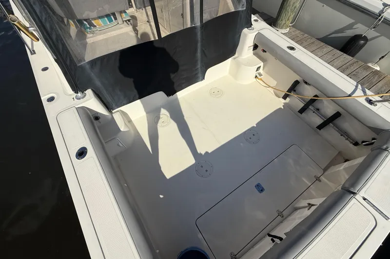 Slide: The Image of 2004 Pursuit 3100 Offshore boat deck with seating and storage compartments. - 5