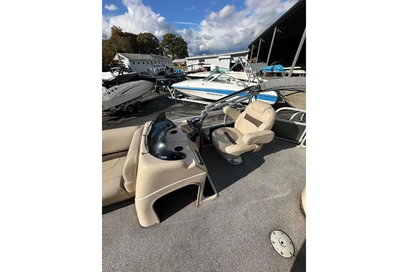 Slide: The Image of 2017 Sun Tracker Party Barge 20 DLX interior with captain's chair and dashboard. - 10