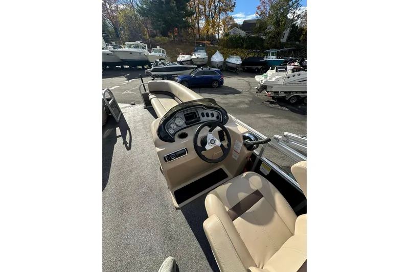 Slide: The Image of 2017 Sun Tracker Party Barge 20 DLX interior with steering wheel and seating. - 11