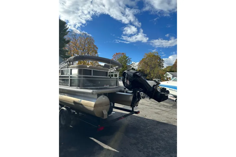 Slide: The Image of 2017 Sun Tracker Party Barge 20 DLX pontoon boat on trailer under blue sky. - 3