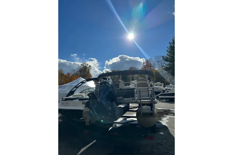 Slide: The Image of 2017 Sun Tracker Party Barge 20 DLX pontoon boat under bright sunlit sky. - 4