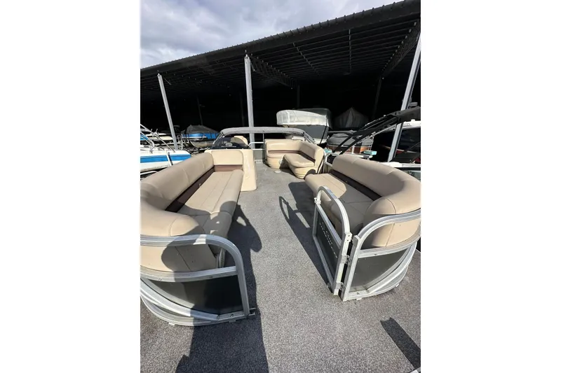 Slide: The Image of 2017 Sun Tracker Party Barge 20 DLX with spacious seating under a covered dock. - 6