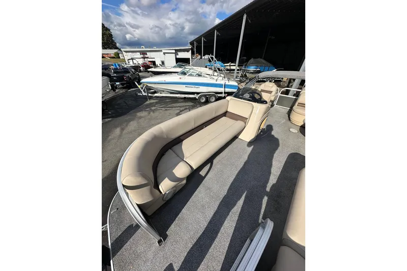 Slide: The Image of 2017 Sun Tracker Party Barge 20 DLX pontoon boat with beige seating, parked outdoors. - 8