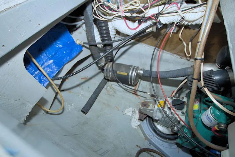 Slide: The Image of Engine compartment of a 1996 Manta 40 sailboat with visible wiring and components. - 100