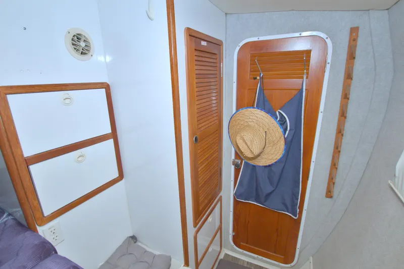 Slide: The Image of Interior of 1996 Manta 40 boat with wooden cabinets and door, hat hanging. - 101