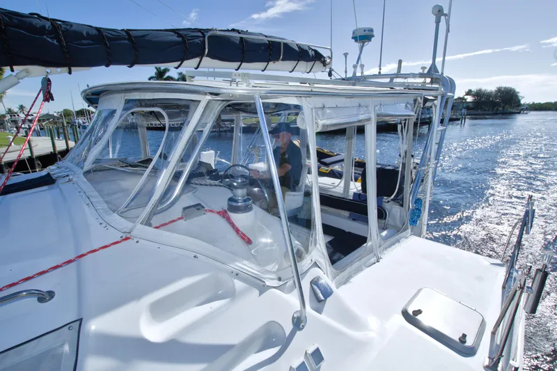 Slide: The Image of 1996 Manta 40 sailboat with enclosed cockpit on a sunny day by the water. - 12