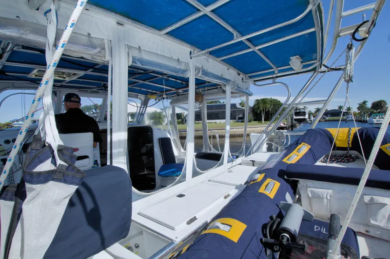 Slide: The Image of Interior view of a 1996 Manta 40 catamaran with blue and white seating. - 16