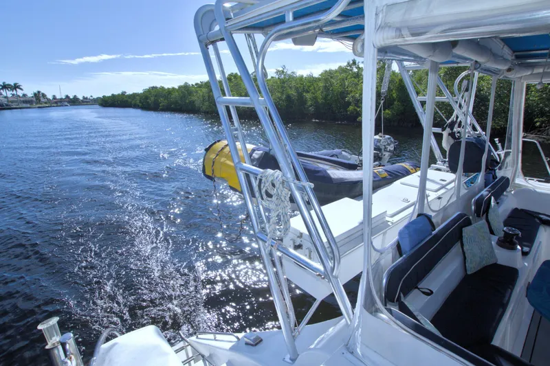 Slide: The Image of 1996 Manta 40 catamaran on a sunny river, featuring sleek design and comfortable seating. - 35