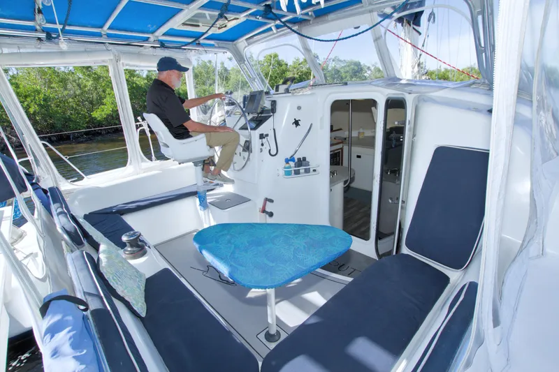 Slide: The Image of Interior of a 1996 Manta 40 catamaran with helm, seating, and cabin entrance. - 36