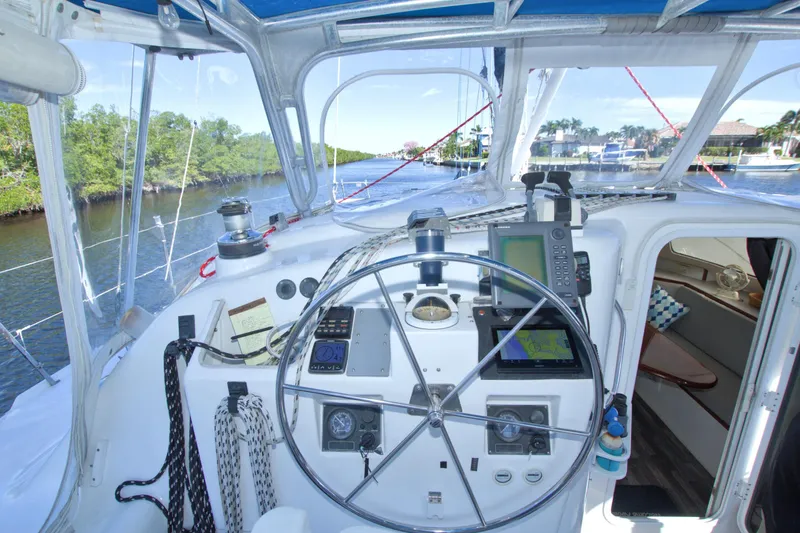 Slide: The Image of Cockpit of 1996 Manta 40 sailboat with navigation equipment and steering wheel. - 43