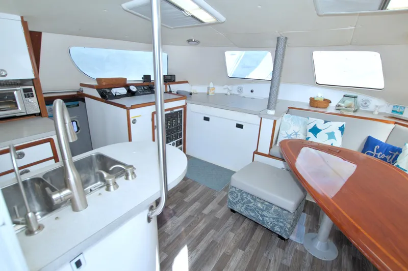 Slide: The Image of Interior of 1996 Manta 40 yacht with modern kitchen and cozy seating area. - 48