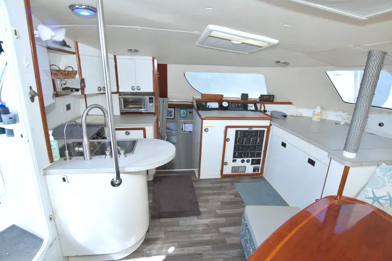 Slide: The Image of Interior of 1996 Manta 40 yacht with kitchen and navigation area. - 49
