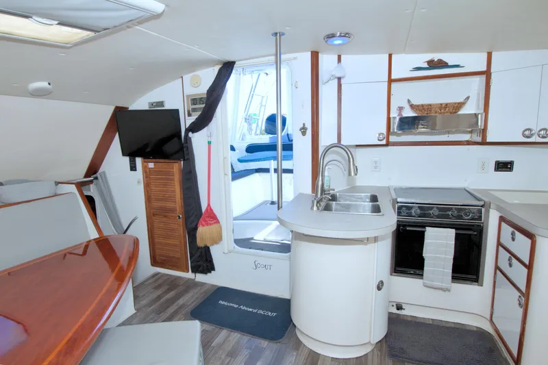 Slide: The Image of Interior of 1996 Manta 40 yacht featuring kitchen, dining area, and modern amenities. - 50
