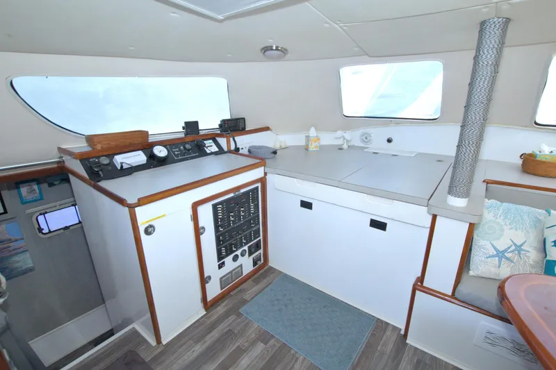 Slide: The Image of Interior of a 1996 Manta 40 boat with navigation controls and seating area. - 53
