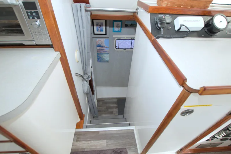 Slide: The Image of Interior view of a 1996 Manta 40 yacht, featuring stairs and modern appliances. - 56