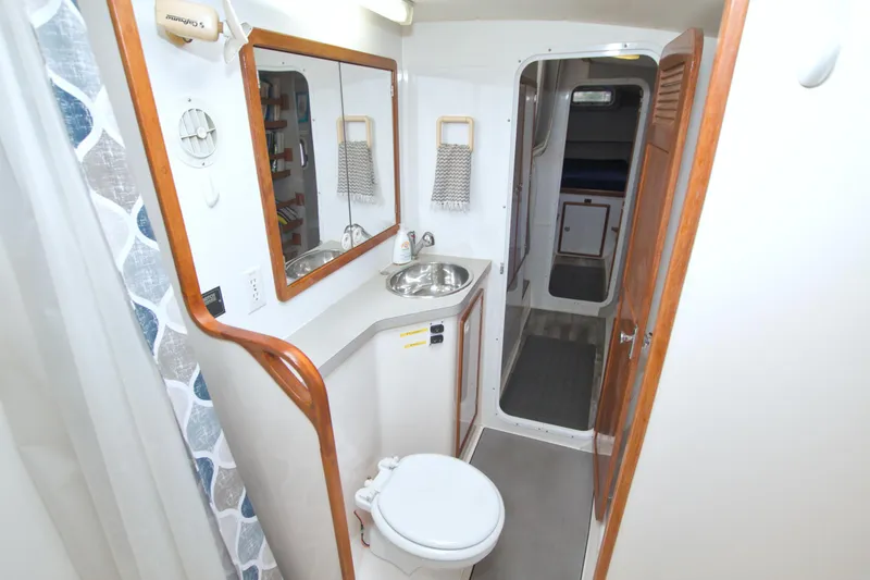 Slide: The Image of 1996 Manta 40 yacht bathroom with sink, mirror, and toilet. - 62