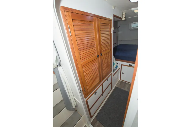 Slide: The Image of Interior of 1996 Manta 40 sailboat with wooden closet and cozy cabin space. - 64