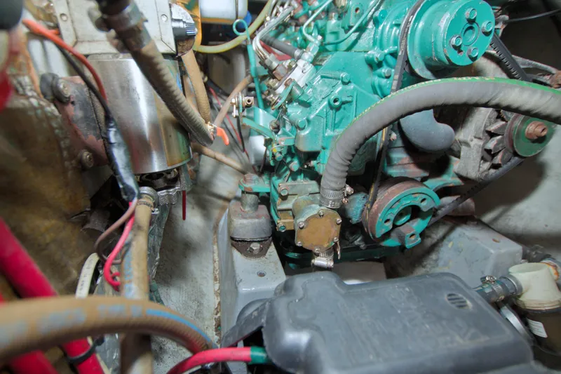 Slide: The Image of Engine compartment of a 1996 Manta 40 sailboat, showcasing mechanical components and wiring. - 71
