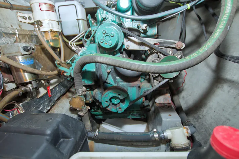 Slide: The Image of Engine compartment of a 1996 Manta 40 boat, showcasing mechanical components and hoses. - 72