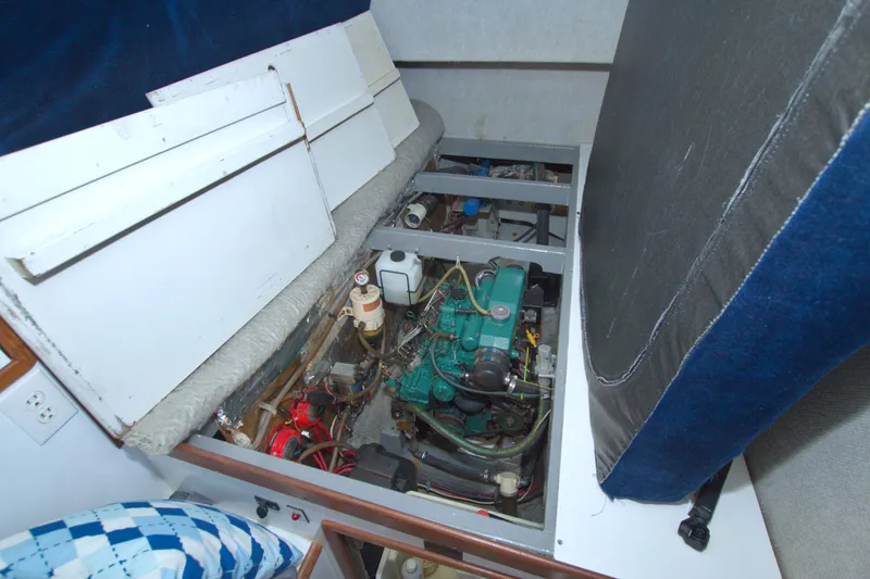 Slide: The Image of Engine compartment of a 1996 Manta 40 boat, showcasing mechanical components and storage. - 73
