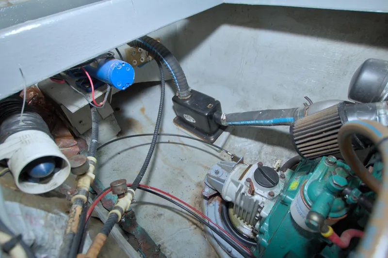 Slide: The Image of Engine compartment of a 1996 Manta 40 boat, showing mechanical components and wiring. - 75