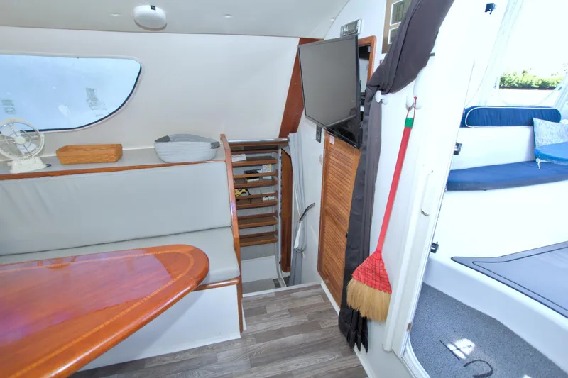 Slide: The Image of Interior of 1996 Manta 40 yacht with seating, table, and stairs. - 80