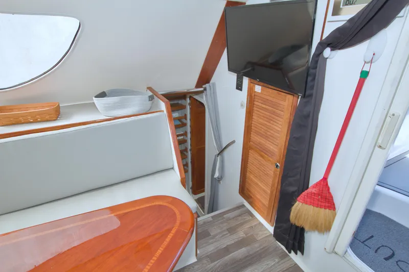 Slide: The Image of Interior of a 1996 Manta 40 boat with TV, seating, and wooden accents. - 81