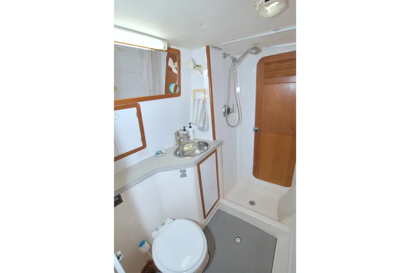 Slide: The Image of 1996 Manta 40 yacht bathroom with shower, sink, and toilet. - 83