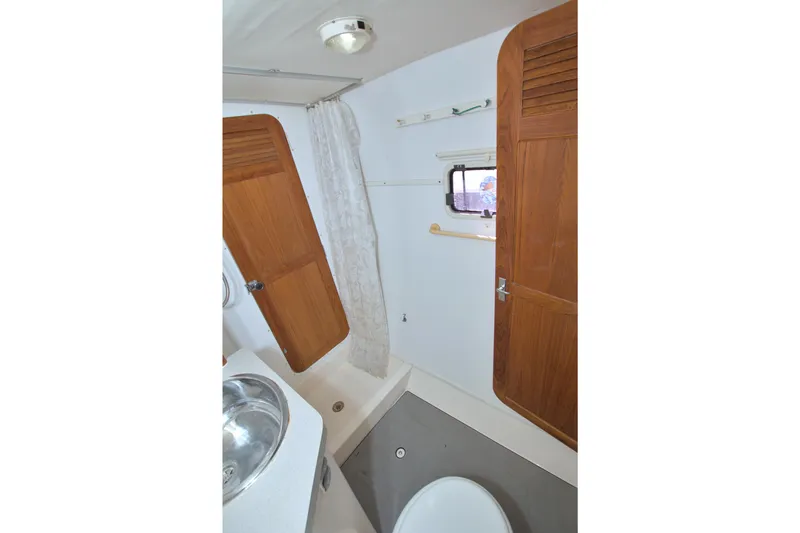 Slide: The Image of 1996 Manta 40 yacht bathroom with wooden cabinets and stainless steel sink. - 84