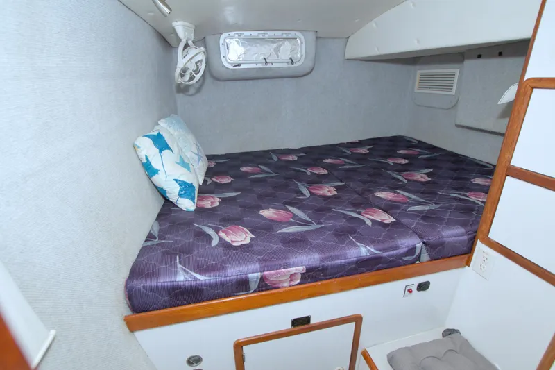 Slide: The Image of Cozy cabin interior of 1996 Manta 40 yacht with floral bedding and pillow. - 93