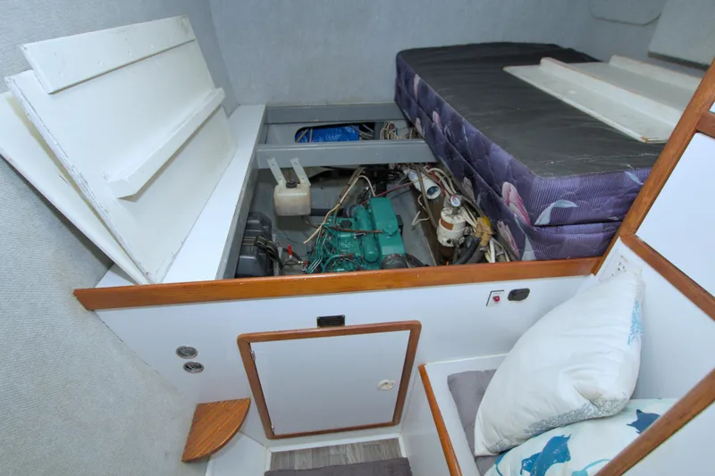 Slide: The Image of 1996 Manta 40 interior showing engine compartment beneath bed with accessible panels. - 96