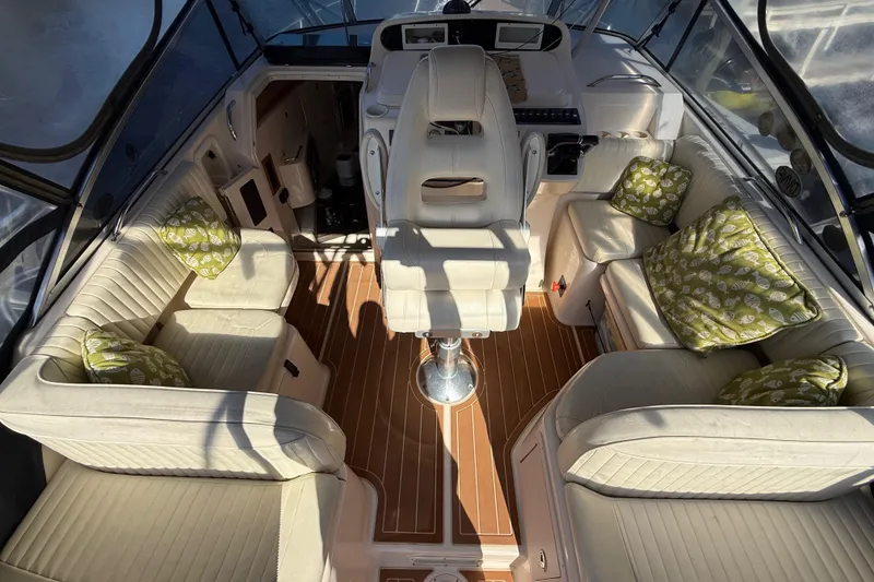 Slide: The Image of Interior of 2005 Grady-White Express 330 boat with cushioned seating and decorative pillows. - 11