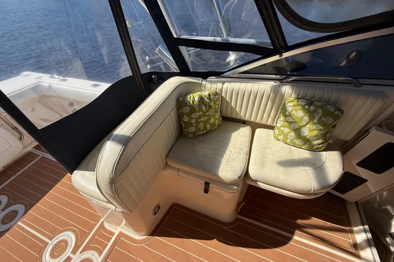 Slide: The Image of 2005 Grady-White Express 330 helm with steering wheel and navigation system. - 12