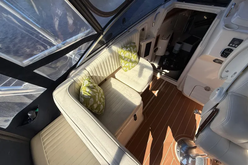Slide: The Image of 2005 Grady-White Express 330 boat interior with cushioned seating and helm. - 13