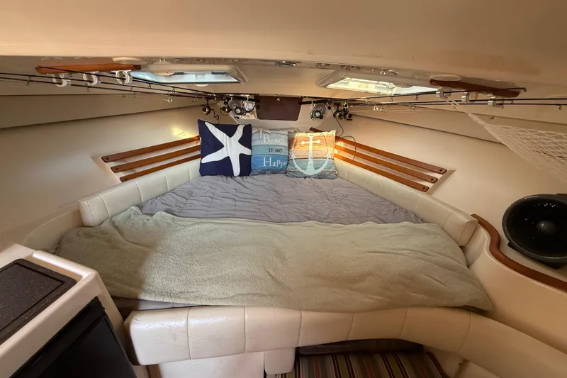 Slide: The Image of 2005 Grady-White Express 330 cabin with kitchenette, sink, microwave, and compact fridge. - 17