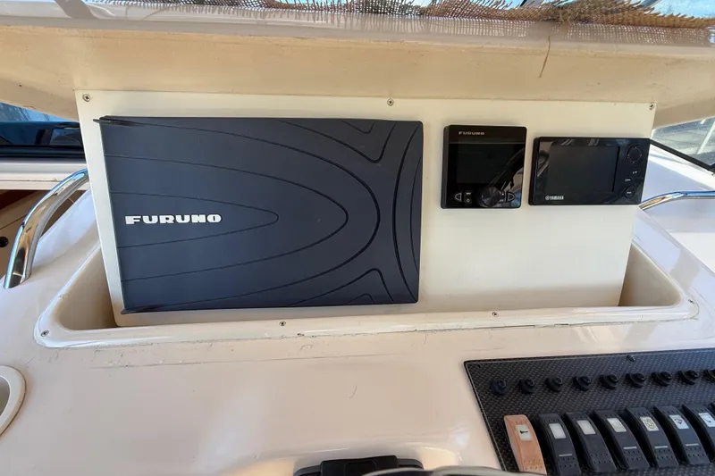 Slide: The Image of Compact bathroom in 2005 Grady-White Express 330 boat, featuring sink, toilet, and storage. - 20