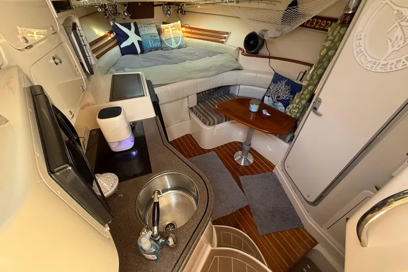 Slide: The Image of 2005 Grady-White Express 330 cabin interior with steps and sleeping area. - 23