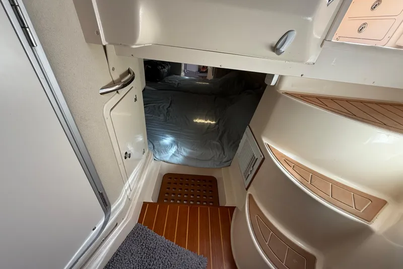 Slide: The Image of 2005 Grady-White Express 330 cabin interior with cozy seating and wooden table. - 25