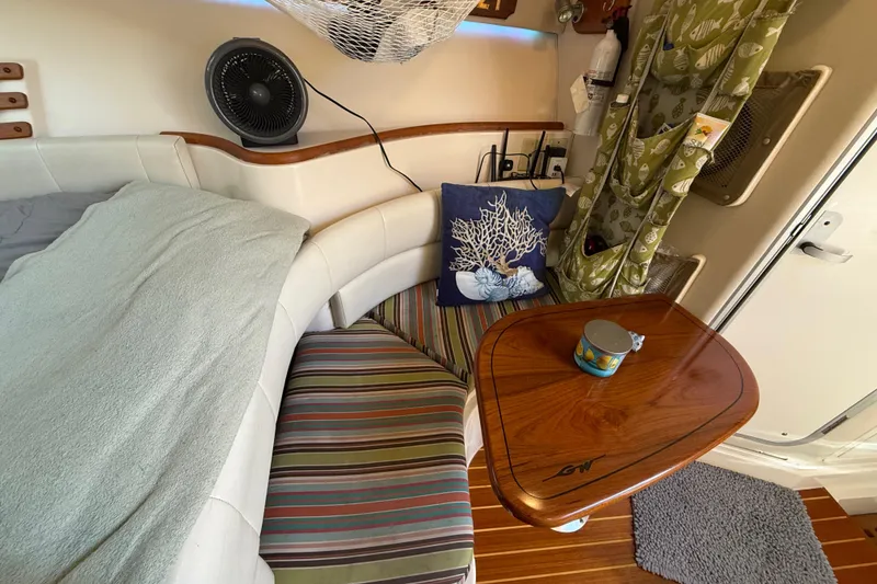 Slide: The Image of 2005 Grady-White Express 330 cabin interior with kitchenette, microwave, and storage cabinets. - 27