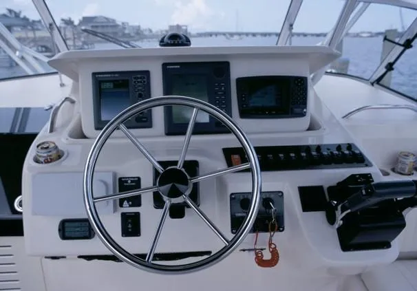 Slide: The Image of 2005 Grady-White Express 330 boat deck with wood finish and seating area. - 3