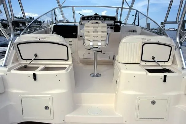 Slide: The Image of 2005 Grady-White Express 330 boat deck with wood finish and dual engines. - 5