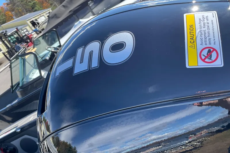 Slide: The Image of 2026 Lund 1875 Crossover XS boat with a 150 HP engine, outdoor setting. - 13