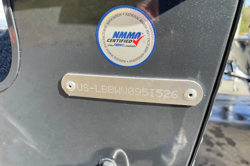 Slide: The Image of 2026 Lund 1875 Crossover XS boat with NMMA certification label and serial number plate. - 14