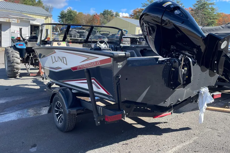 Slide: The Image of 2026 Lund 1875 Crossover XS boat on trailer, parked outdoors. - 3