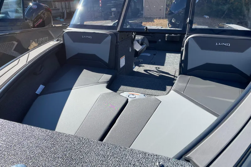 Slide: The Image of 2026 Lund 1875 Crossover XS boat interior with gray seating and modern design. - 5
