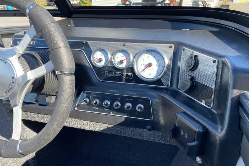 Slide: The Image of Dashboard of 2026 Lund 1875 Crossover XS boat with steering wheel and gauges. - 8